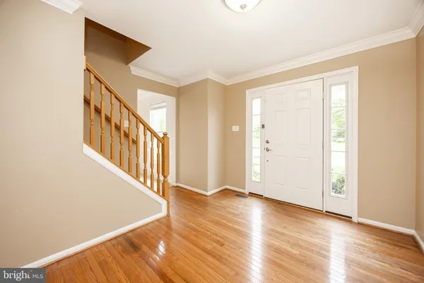 a view of an entryway with wooden floor
