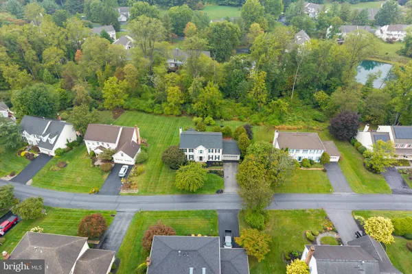 an aerial view of a house with a yard basket ball court and outdoor seating
