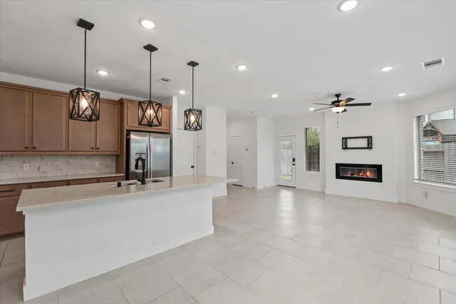 an aerial view of a house with a garden and lake view