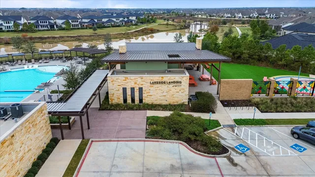 an aerial view of a house with a garden and lake view