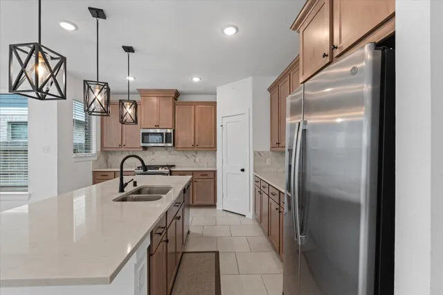 a view of an empty room with a kitchen