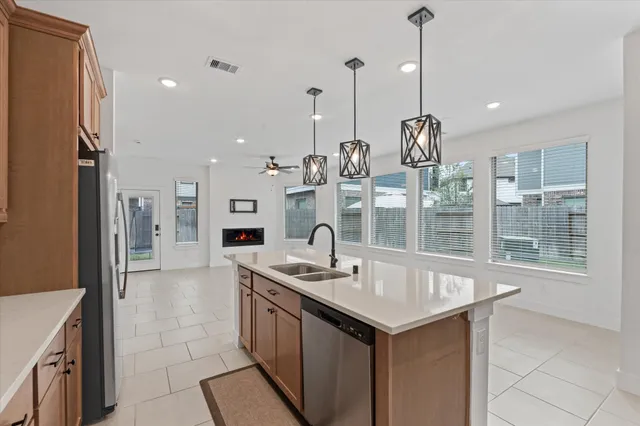 a large kitchen with stainless steel appliances kitchen island a large counter tops and a view of living room