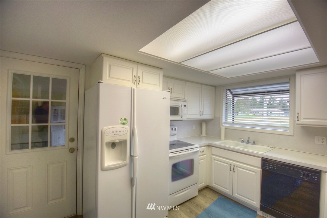 8446 178th Avenue Southwest Rochester, WA 98579 - Photo 11 of 34 a kitchen with a refrigerator and a sink