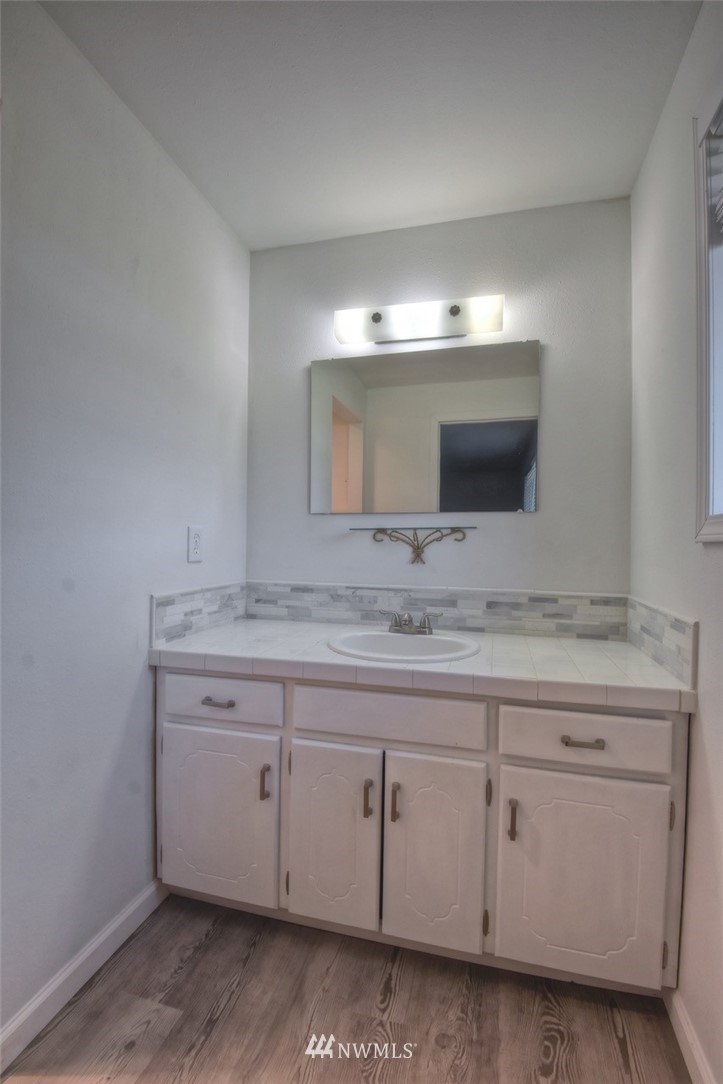8446 178th Avenue Southwest Rochester, WA 98579 - Photo 15 of 34 a bathroom with a granite countertop sink and a mirror