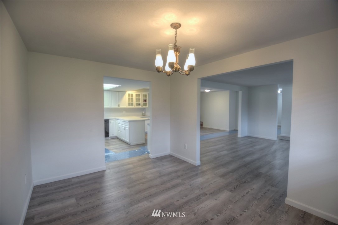 8446 178th Avenue Southwest Rochester, WA 98579 - Photo 7 of 34 wooden floor in an empty room with a window