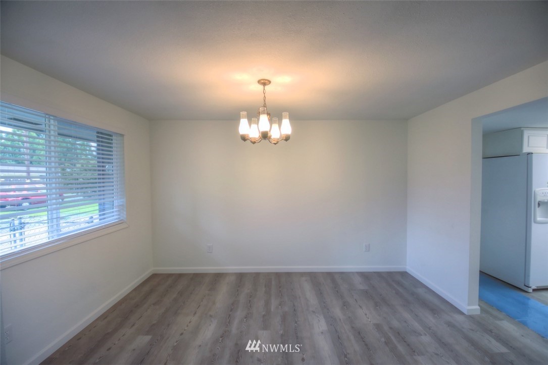8446 178th Avenue Southwest Rochester, WA 98579 - Photo 8 of 34 wooden floor in an empty room with a window