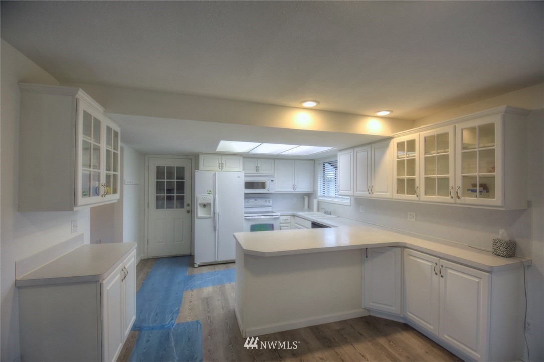 8446 178th Avenue Southwest Rochester, WA 98579 - Photo 10 of 34 a kitchen with a sink cabinets and wooden floor