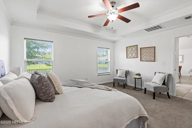 a bedroom with a bed couch and a window