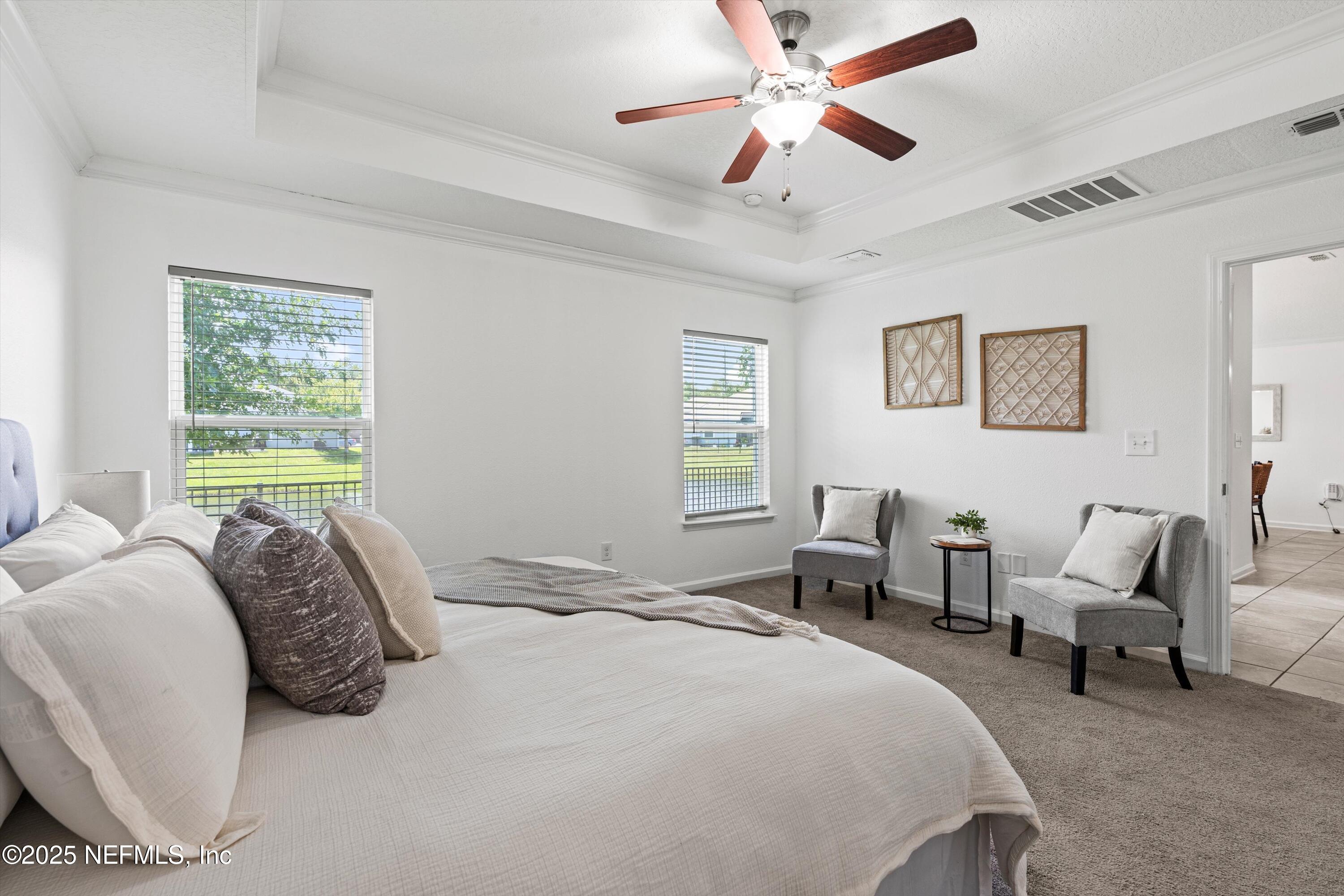 12264 Sacha Road Jacksonville, FL 32226 - Photo 11 of 32 a bedroom with a bed couch and a window