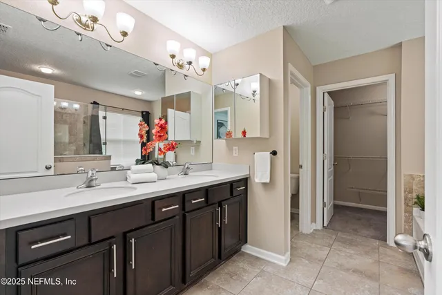 a spacious bathroom with a double vanity sink mirror and double