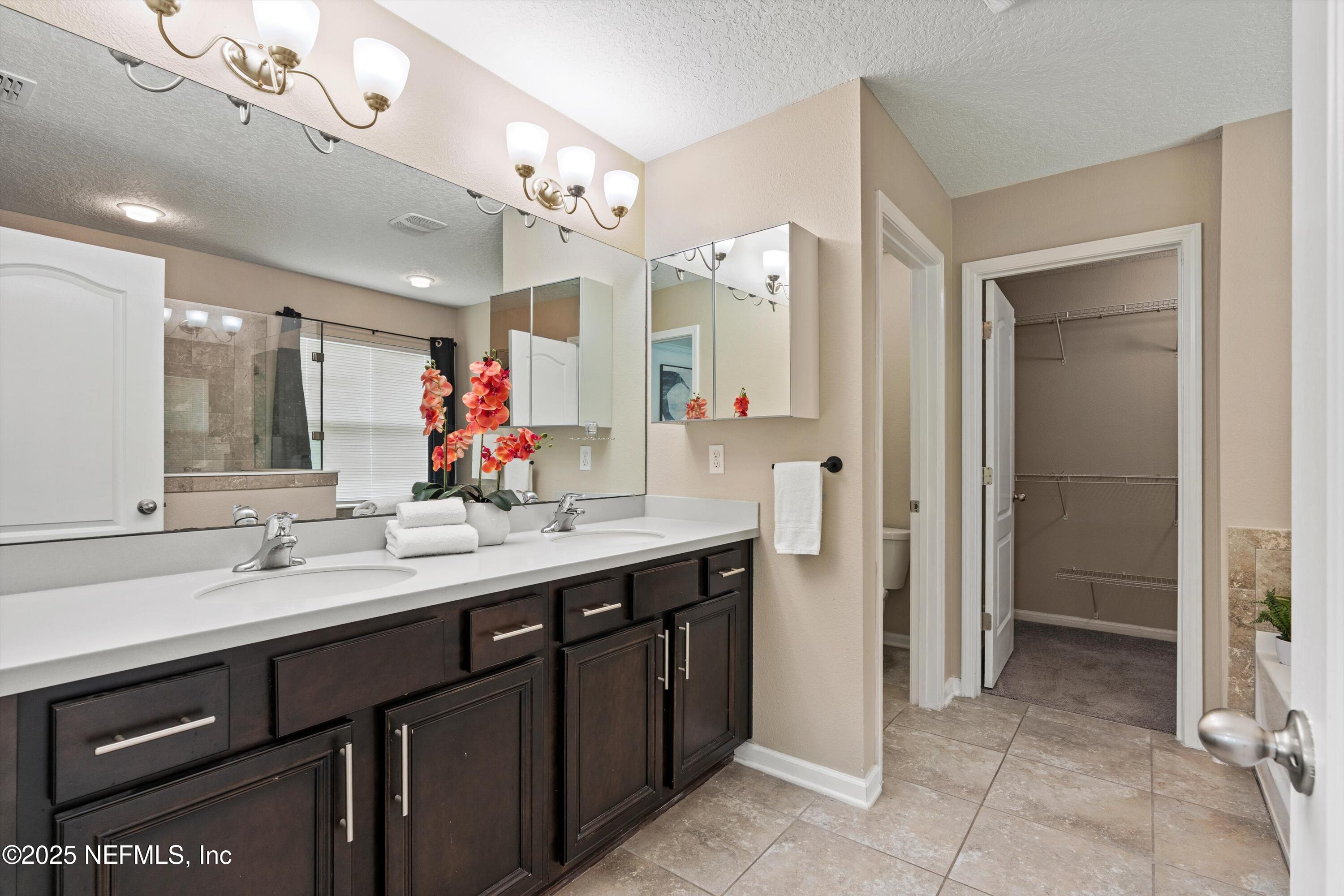 12264 Sacha Road Jacksonville, FL 32226 - Photo 13 of 32 a spacious bathroom with a double vanity sink mirror and double