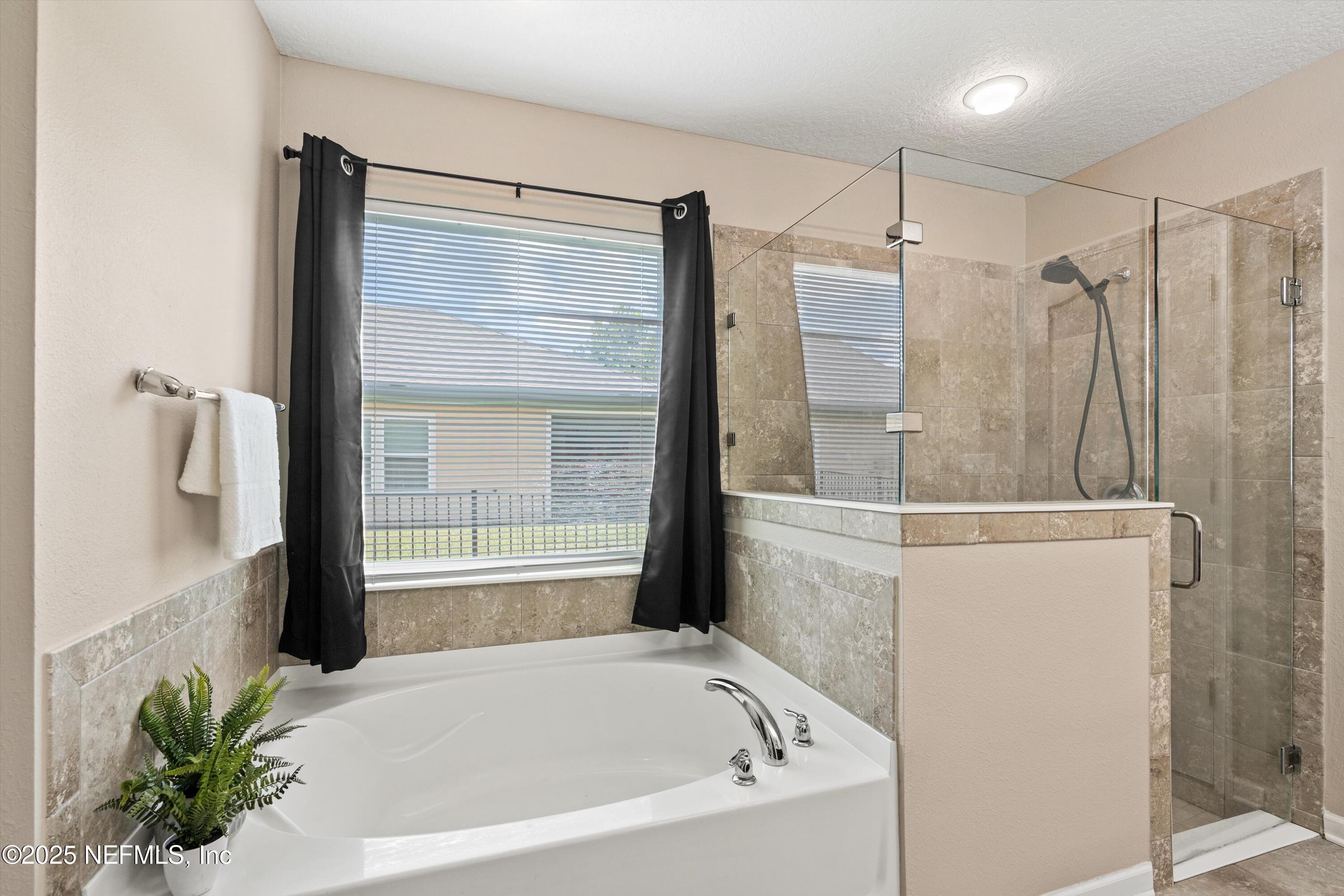 12264 Sacha Road Jacksonville, FL 32226 - Photo 14 of 32 a bathroom with a bathtub and a shower