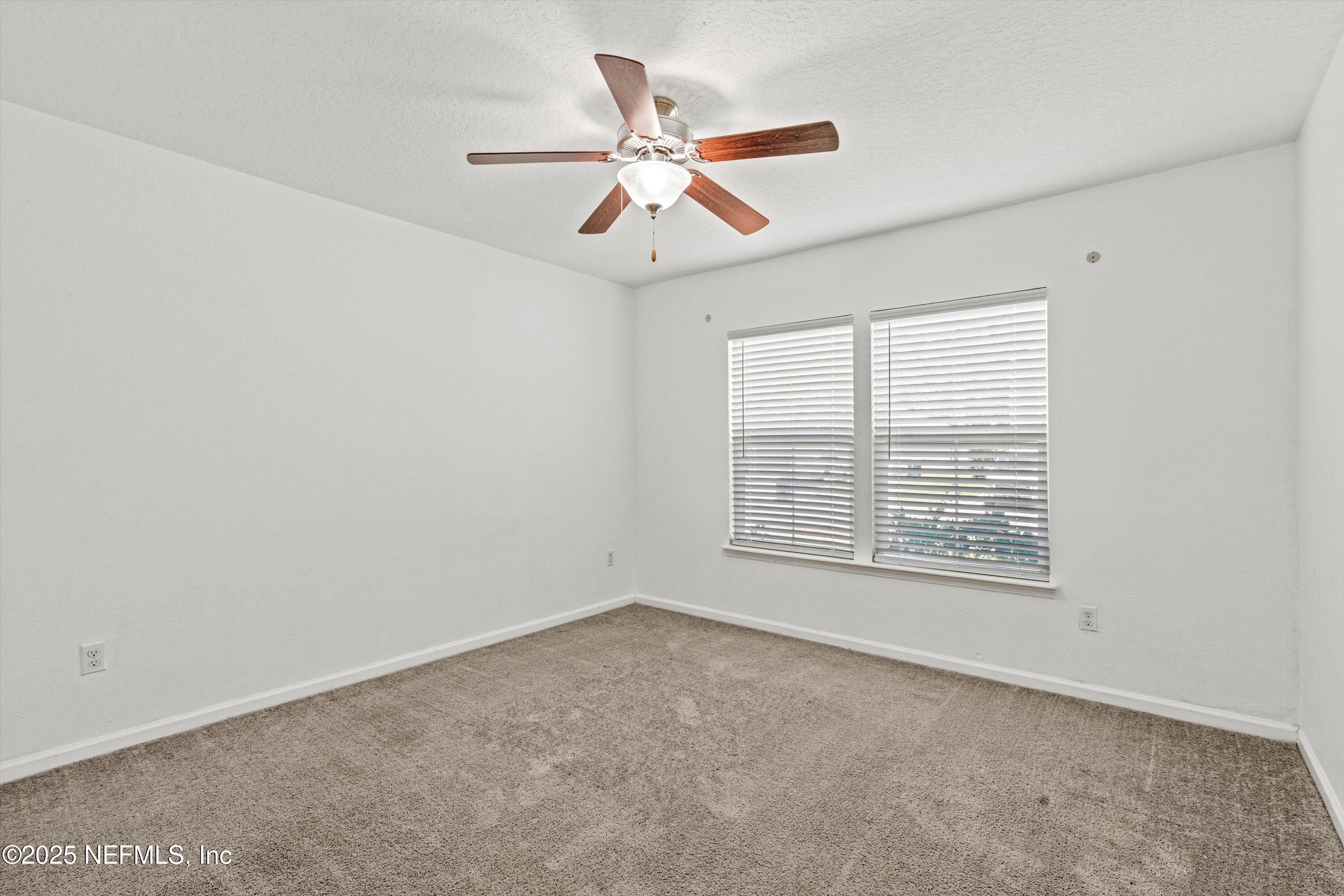 12264 Sacha Road Jacksonville, FL 32226 - Photo 19 of 32 an empty room with fan and windows