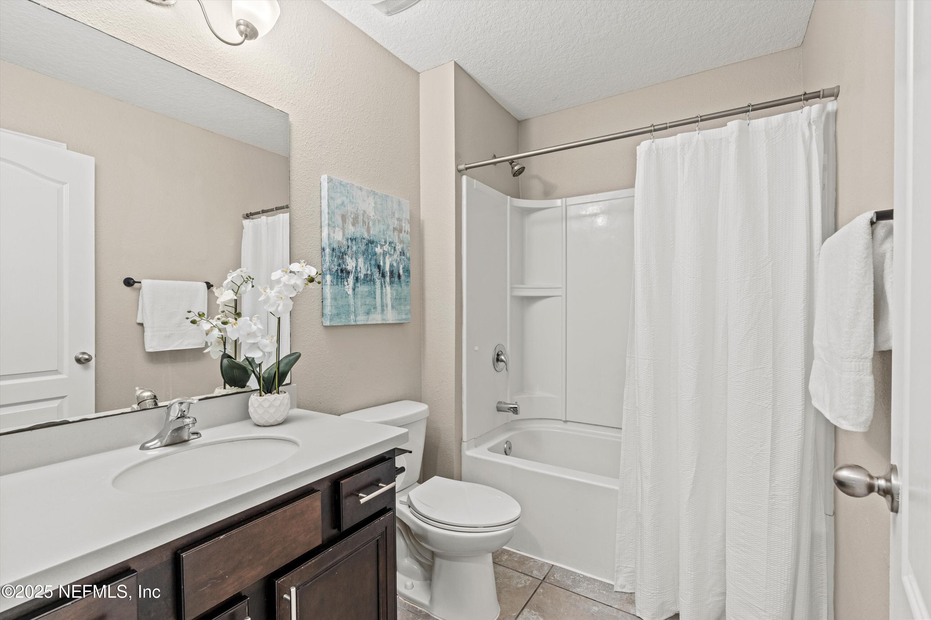 12264 Sacha Road Jacksonville, FL 32226 - Photo 21 of 32 a bathroom with a sink toilet vanity and shower