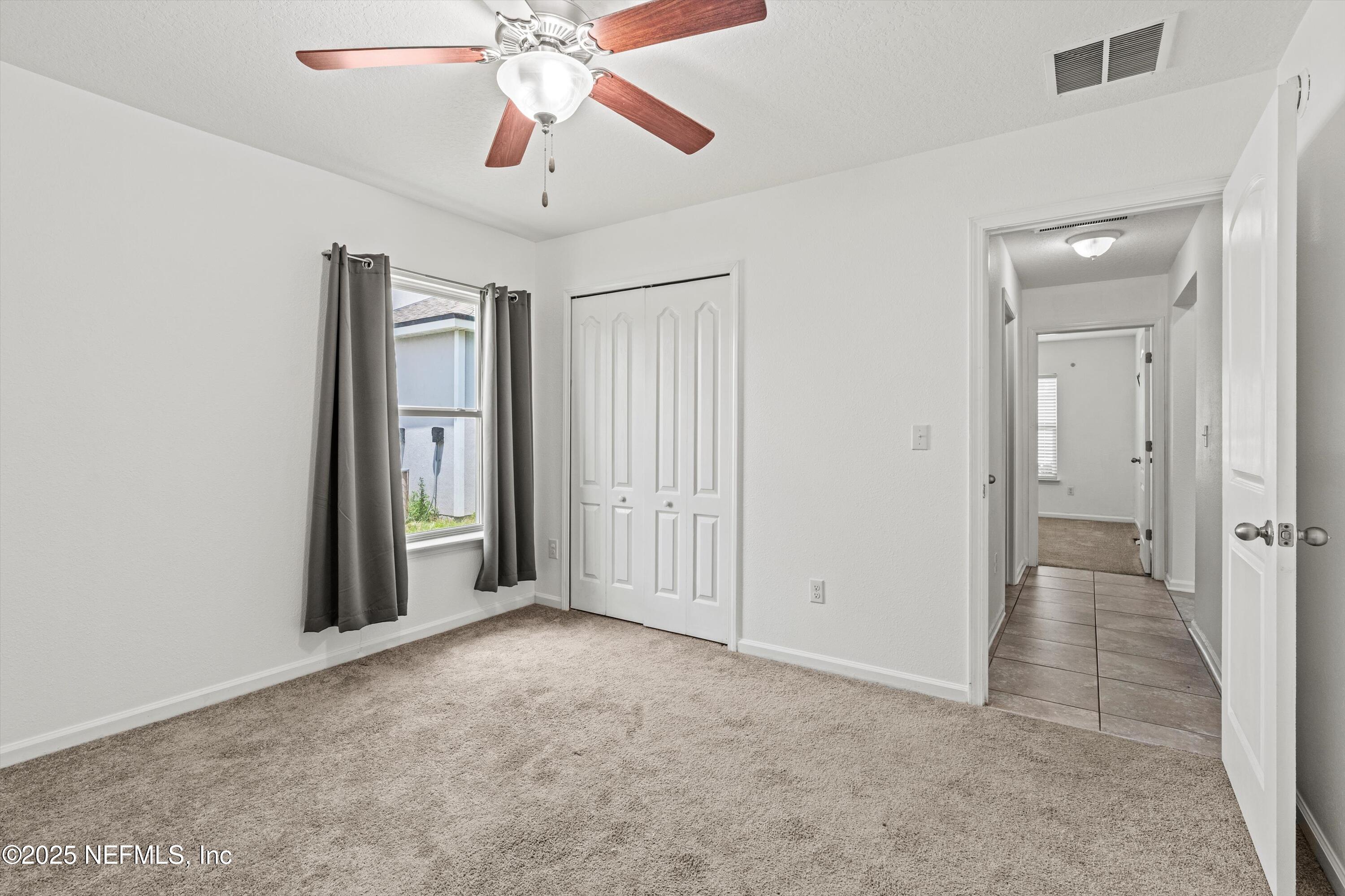 12264 Sacha Road Jacksonville, FL 32226 - Photo 23 of 32 an empty room with fan and entrance