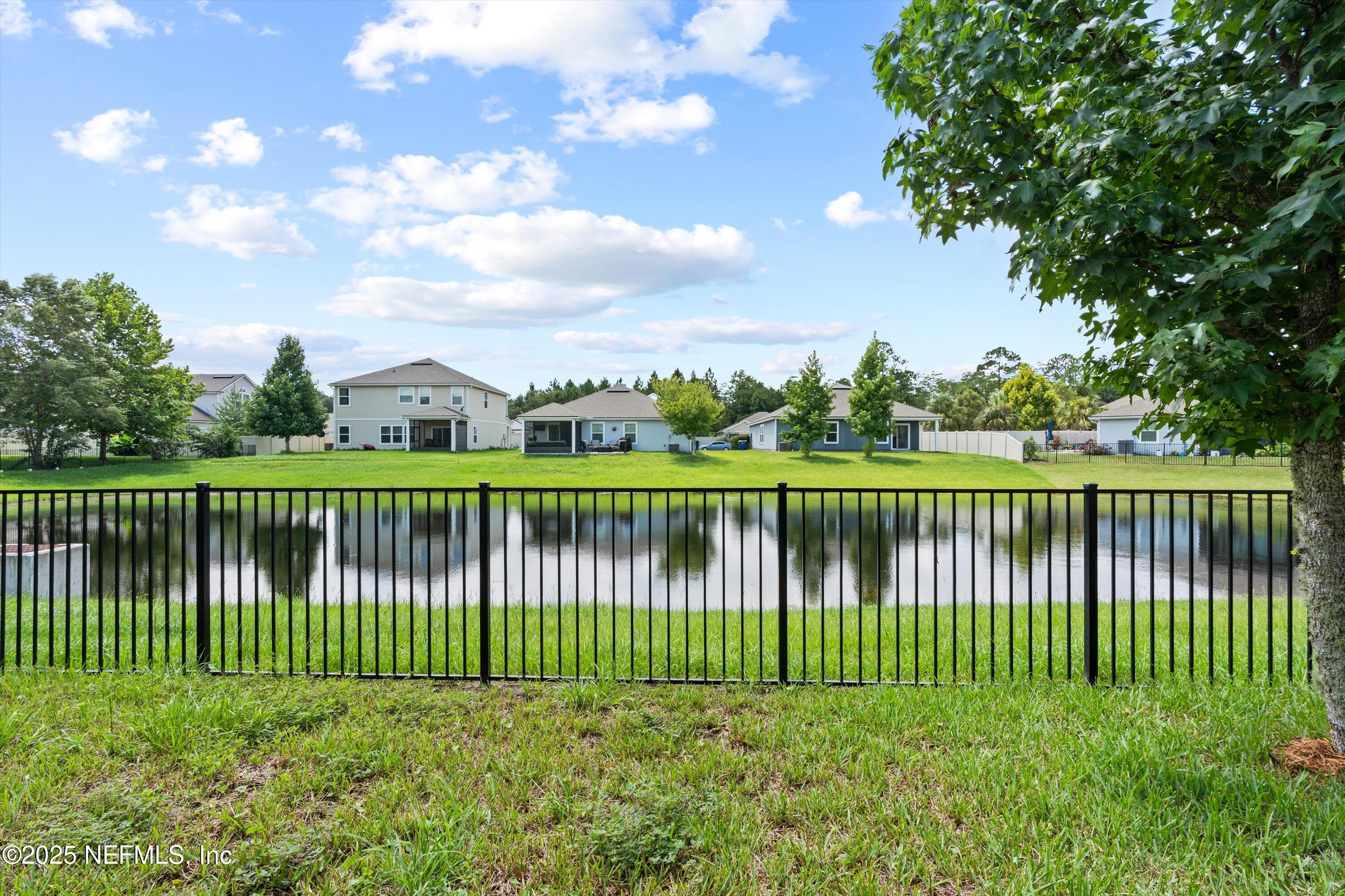 12264 Sacha Road Jacksonville, FL 32226 - Photo 25 of 32 a view of a lake and a fence