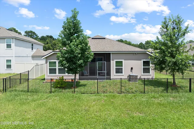 a view of a house with a yard and sitting area