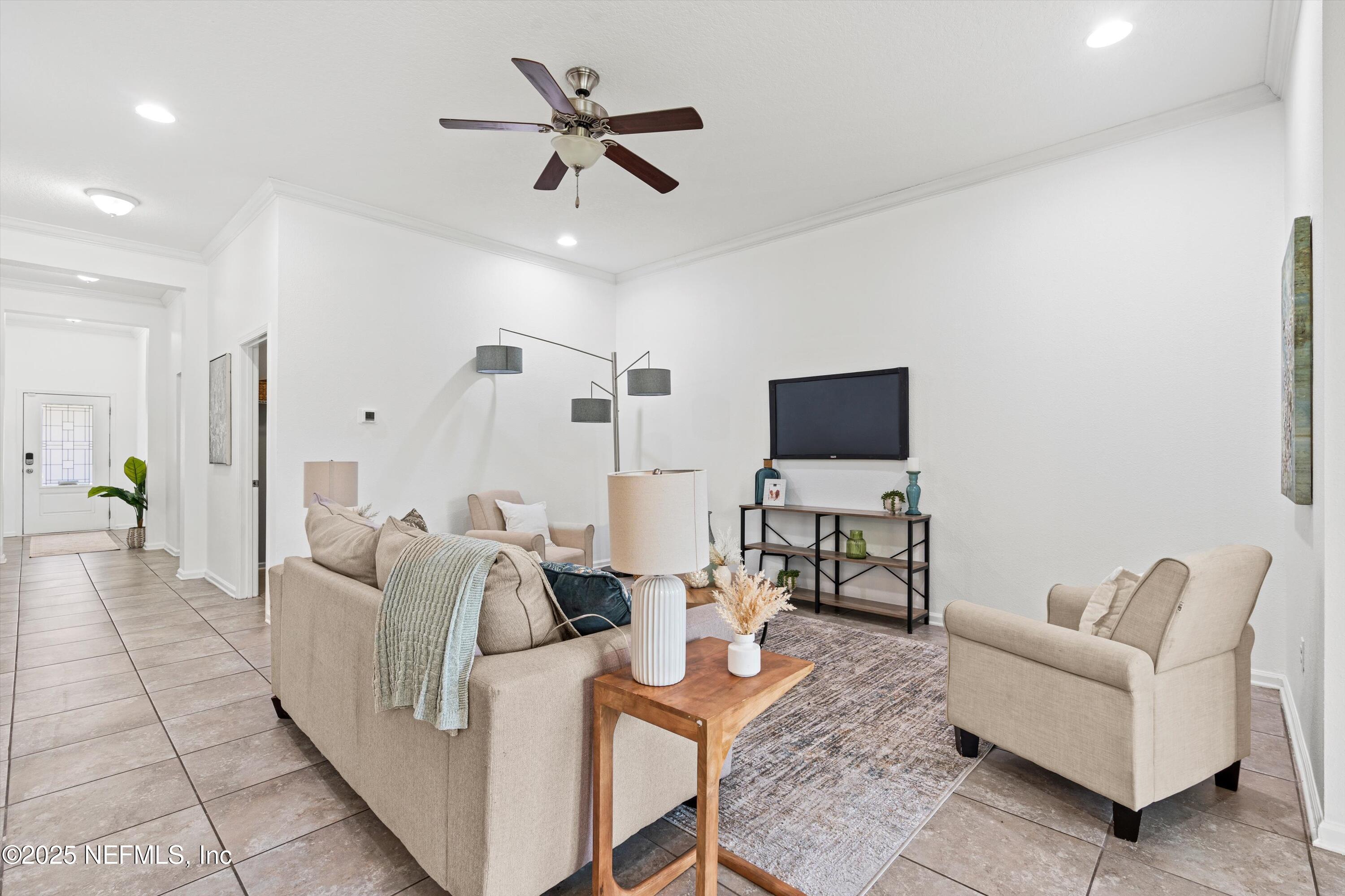 12264 Sacha Road Jacksonville, FL 32226 - Photo 4 of 32 a living room with furniture and a flat screen tv