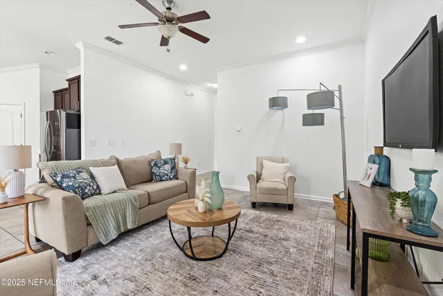 a living room with furniture and a flat screen tv
