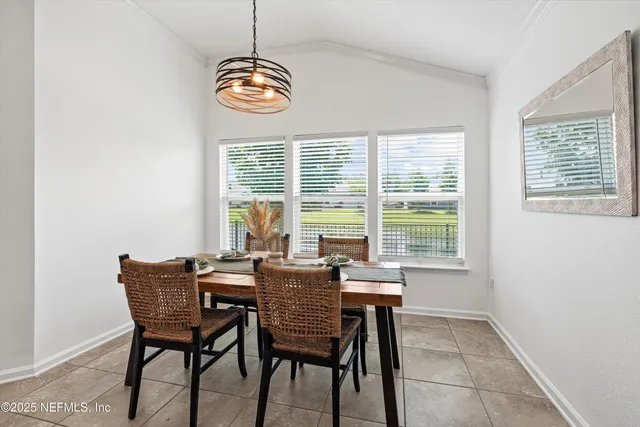 a view of a dining room with furniture window and outside view