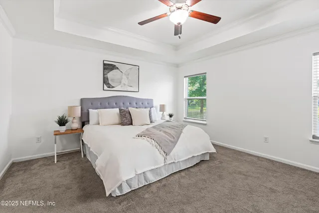 a spacious bedroom with a bed and a chandelier