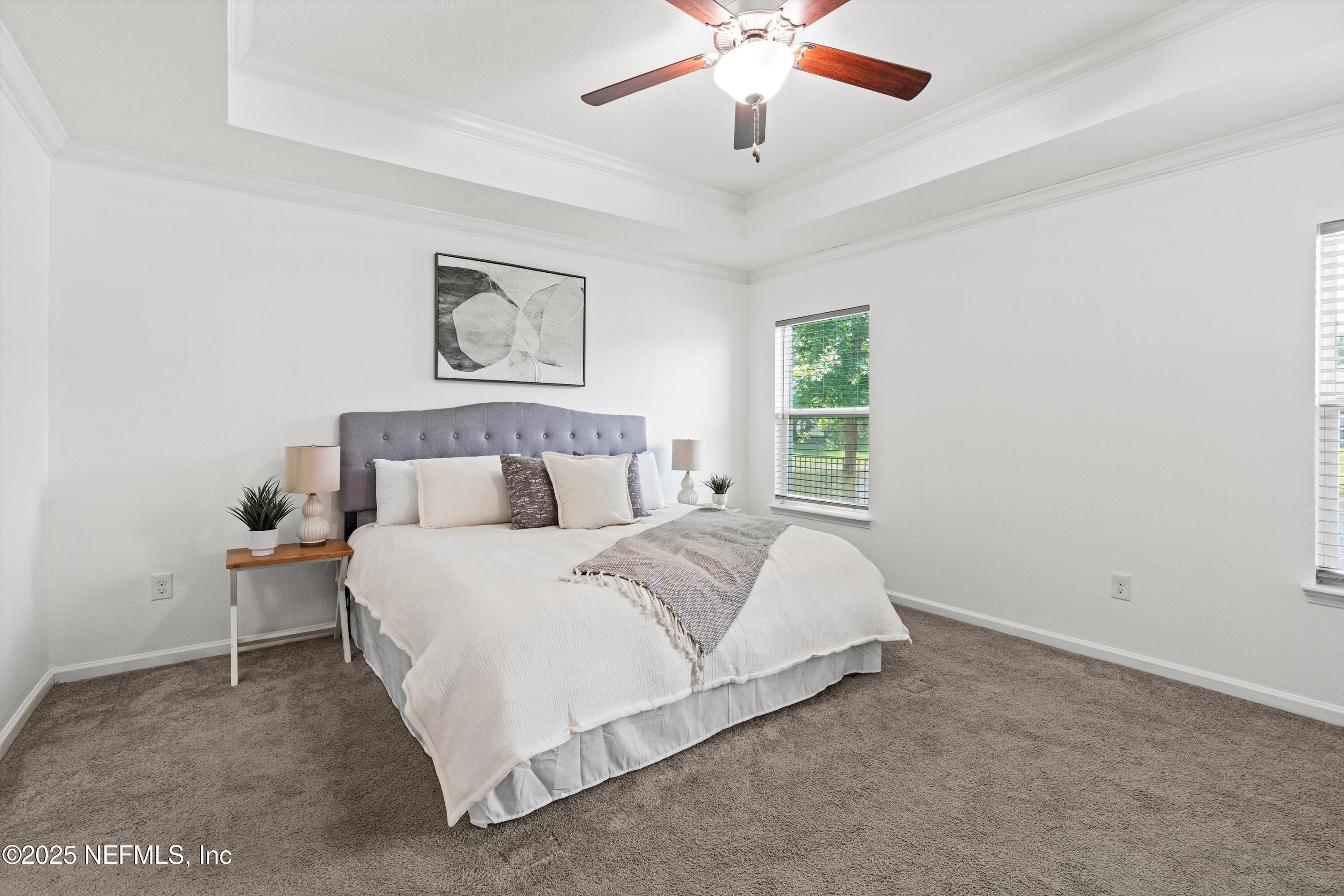 12264 Sacha Road Jacksonville, FL 32226 - Photo 10 of 32 a spacious bedroom with a bed and a chandelier