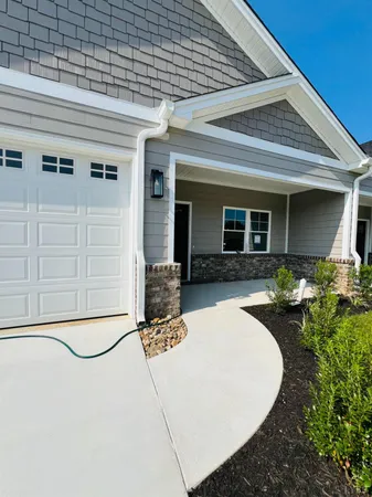 a view of a patio with table and chairs with wooden fence