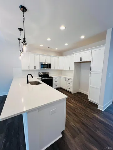 a view of kitchen with sink microwave and refrigerator