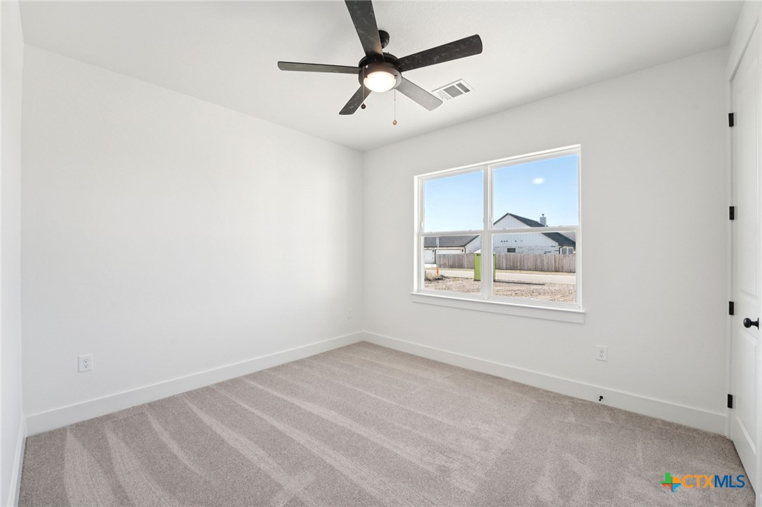 5207 Hollow Ranch Drive Salado, TX 76571 - Photo 24 of 37 an empty room with wooden floor and windows