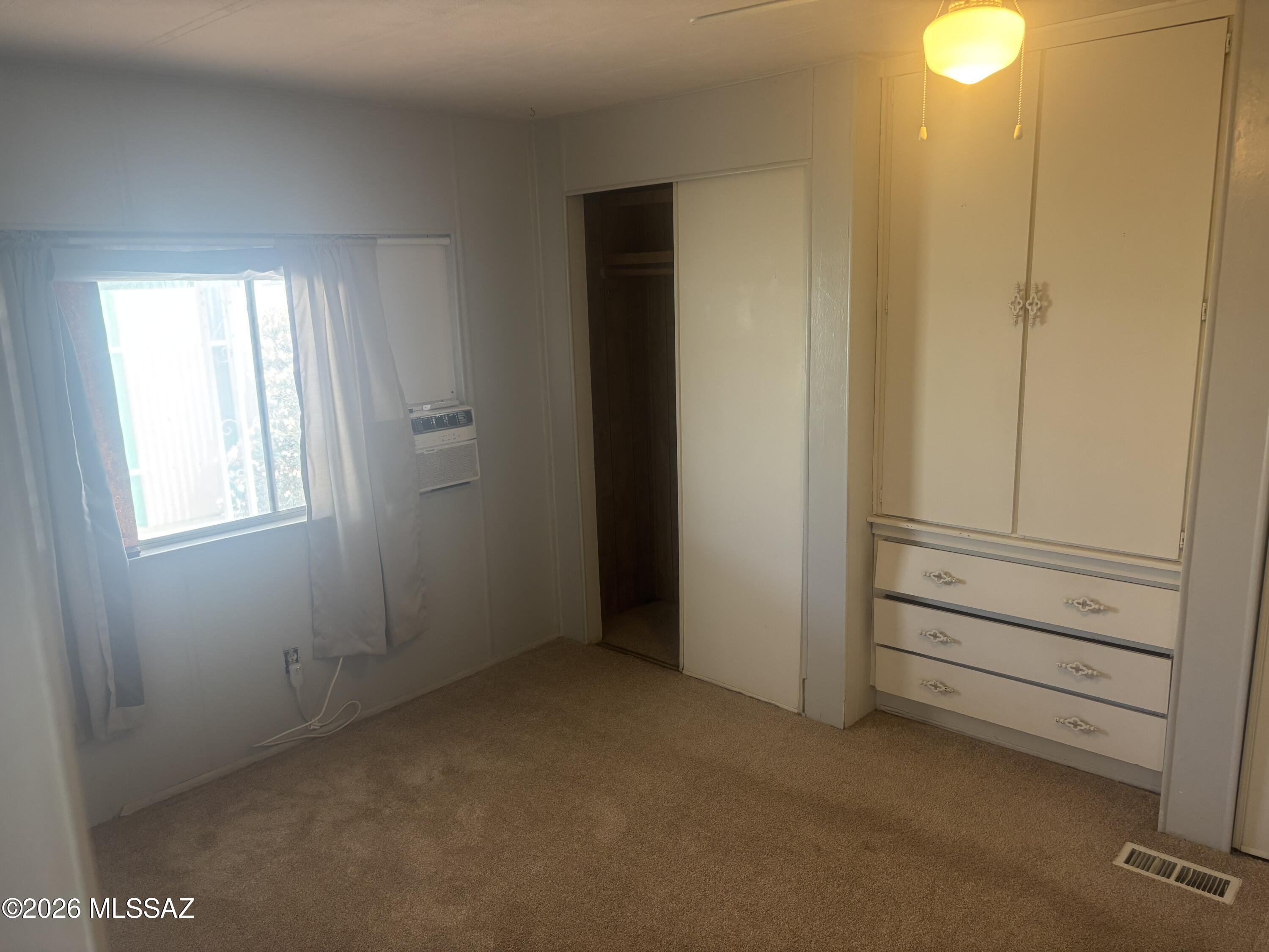 4550 North Flowing Wells Road, Unit 65 Tucson, AZ 85705 - Photo 20 of 50 a view of an empty room and window