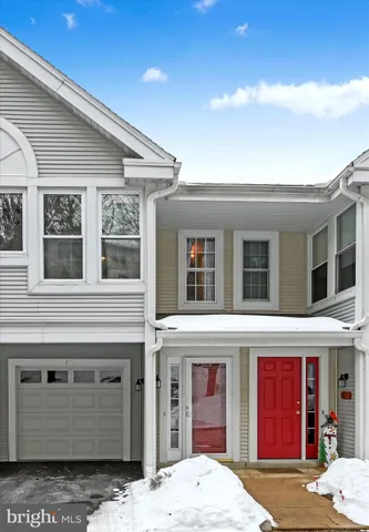 a backyard of a house with white walls