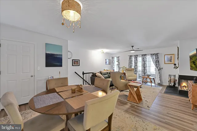 a living room with furniture a chandelier and a flat screen tv