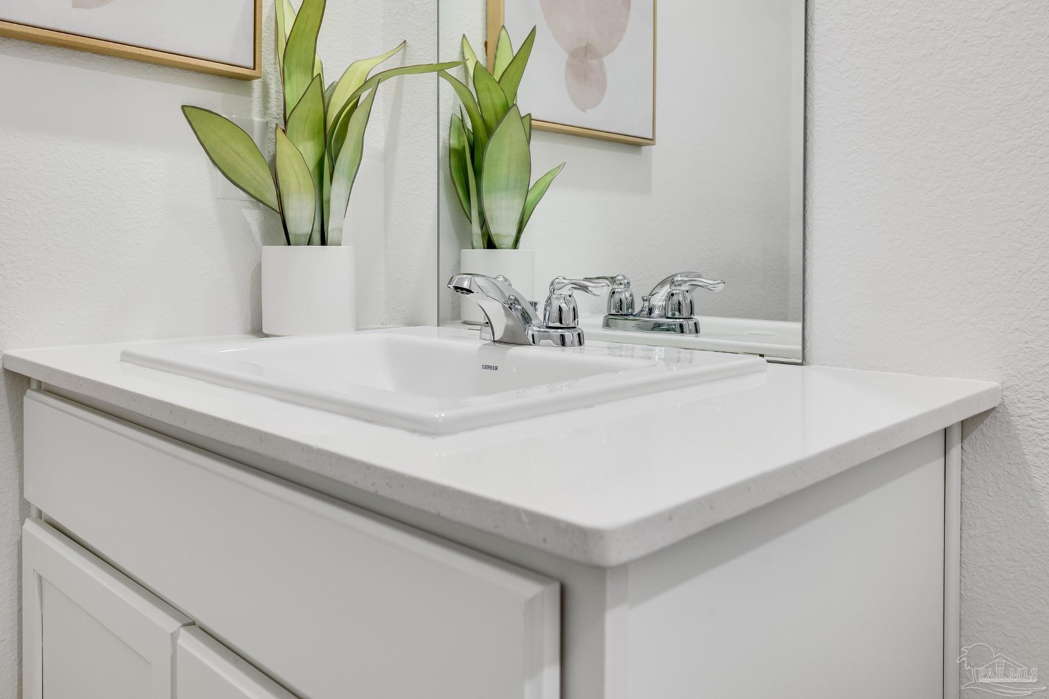 1115 Green Gate Road Cantonment, FL 32533 - Photo 41 of 47 a bathroom with a sink a mirror and a potted plant