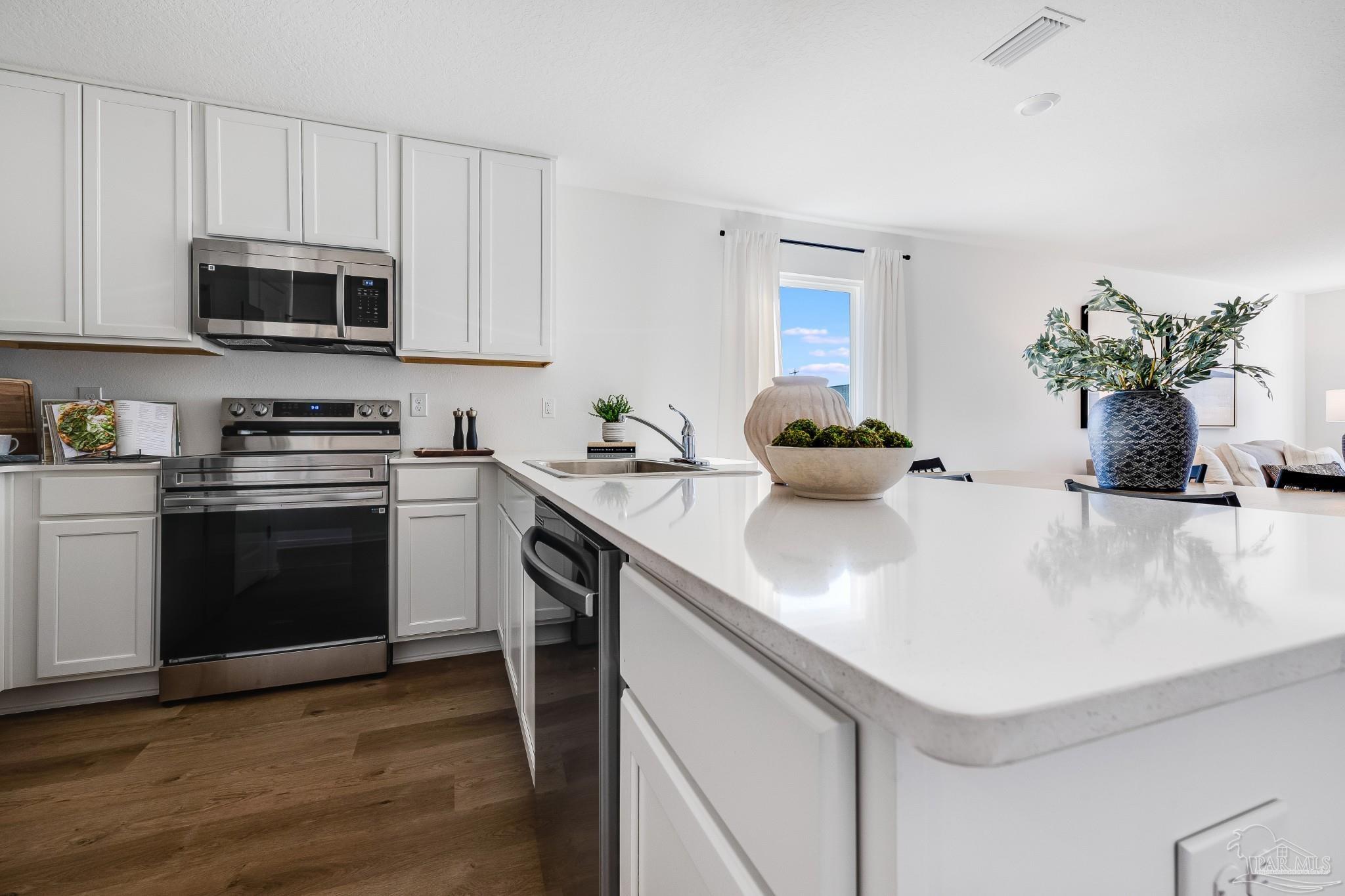 1115 Green Gate Road Cantonment, FL 32533 - Photo 10 of 47 a kitchen with stainless steel appliances white cabinets and a sink