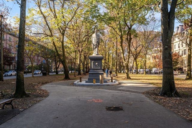 a front view of a house with a tree