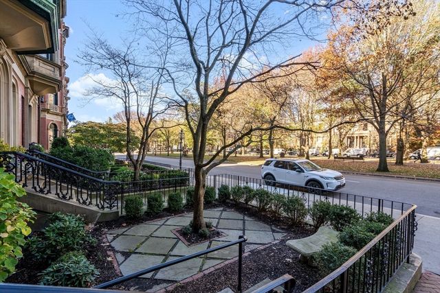 a view of a street with wooden fence