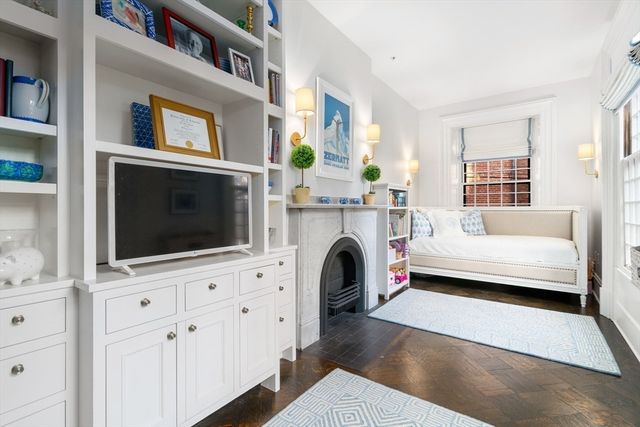 a living room with fireplace furniture and a flat screen tv