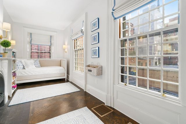 a bedroom with furniture and a large window