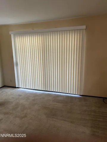 a view of an empty room with a large window