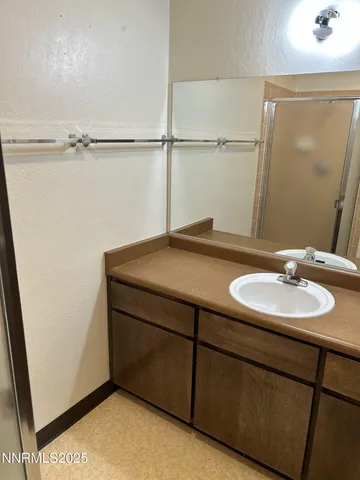 a view of an empty room with wooden floor and windows