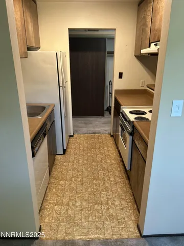 a bathroom with a sink a toilet a washer and dryer