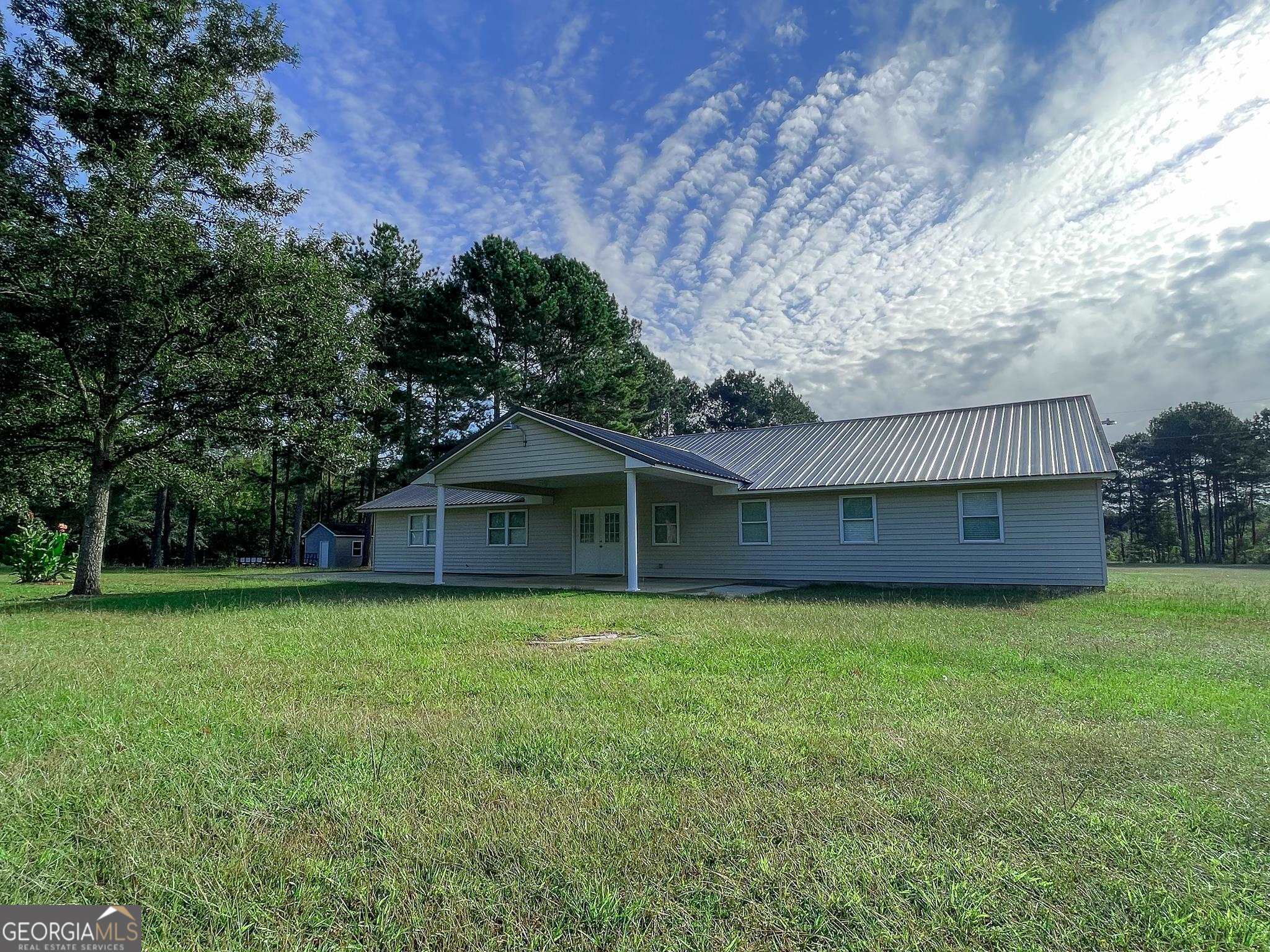1095 Braddy Road Bartow, GA 30413 - Photo 1 of 1 a front view of a house with garden