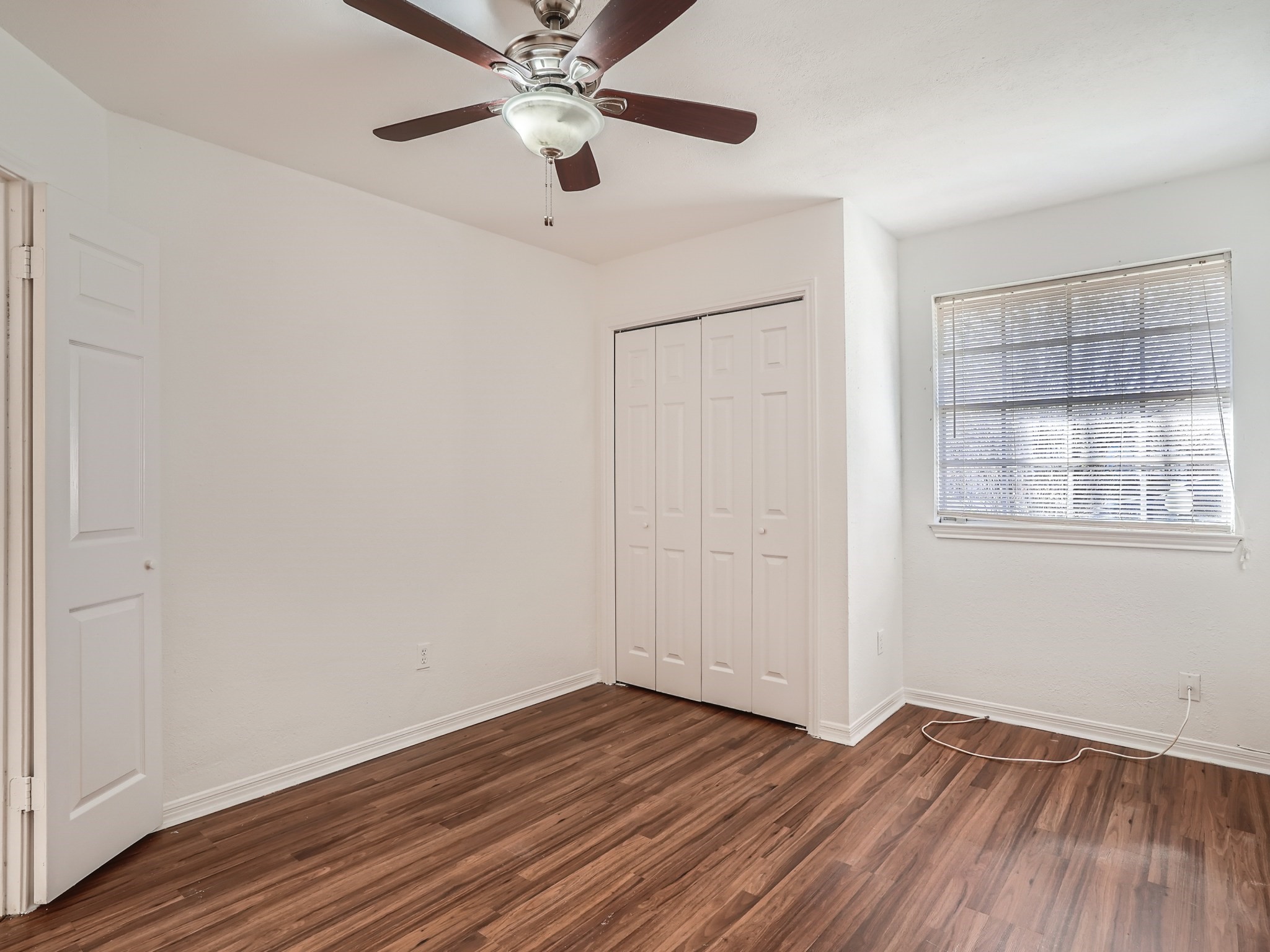 811 Canyon Bend Road Pflugerville, TX 78660 - Photo 9 of 11 an empty room with wooden floor chandelier fan and windows