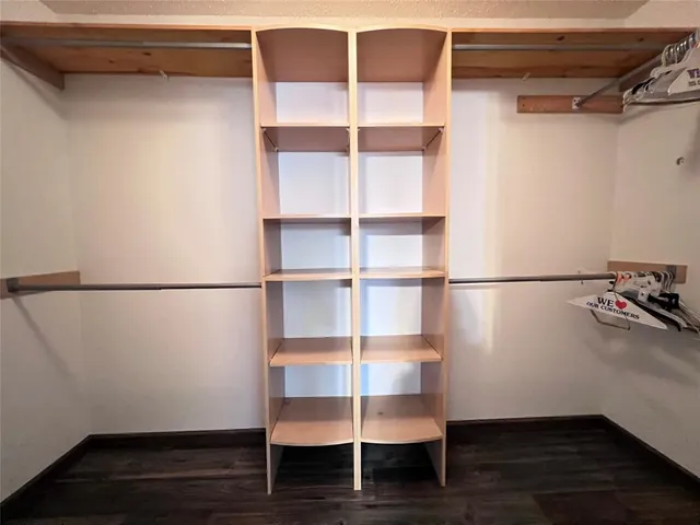 a view of a room with wooden floor and shelf