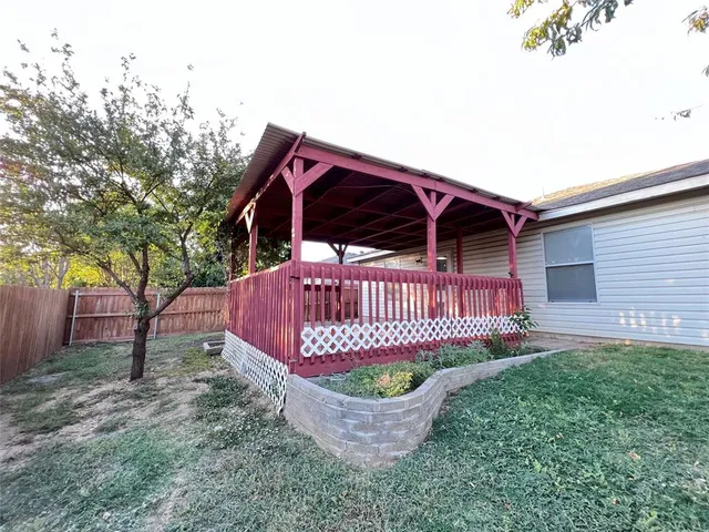 a view of a backyard with a small cabin and a chair