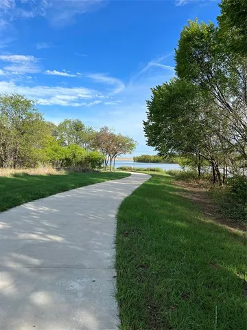 a view of a yard with big trees