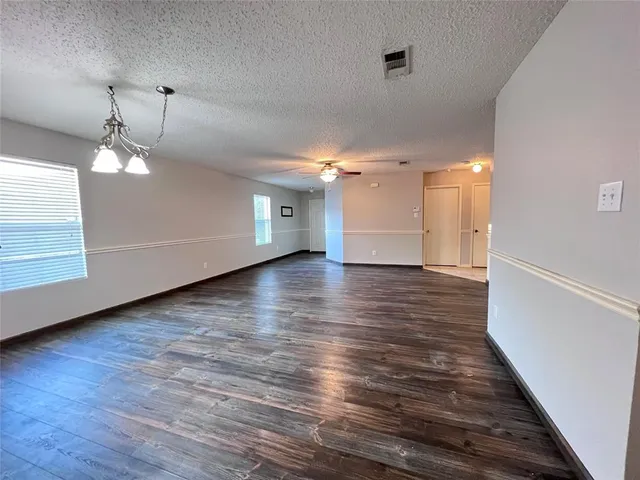 a view of a room with wooden floor