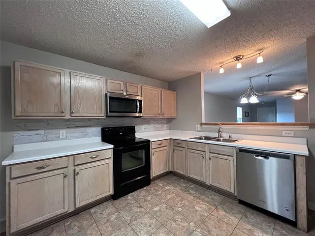 a kitchen with sink cabinets and microwave