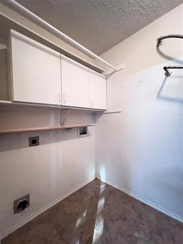a view of storage and utility room with a window