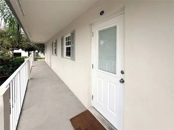 a view of a hallway with wooden floor and stairs